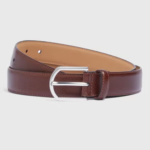 Our Tan PU Brogue Belt is a must-have accessory for any discerning gentleman. Expertly crafted from premium fabrics, this belt exudes luxury and sophistication. The timeless tan hue adds a touch of elegance to any outfit, featuring a silver hardware buckle and intricate brogue detailing that adds a touch of distinction. 