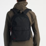 This basic black backpack from Tokyo Laundry features striking red detailing on the zip and a signature Tokyo Laundry badge. Perfect for everyday use, it combines style and practicality with spacious compartments and durable design. With two adjustable padded straps this is a sleek, functional accessory for carrying your essentials in style. Dimensions - H: 41cm, W:28 cm, D: 13cm.